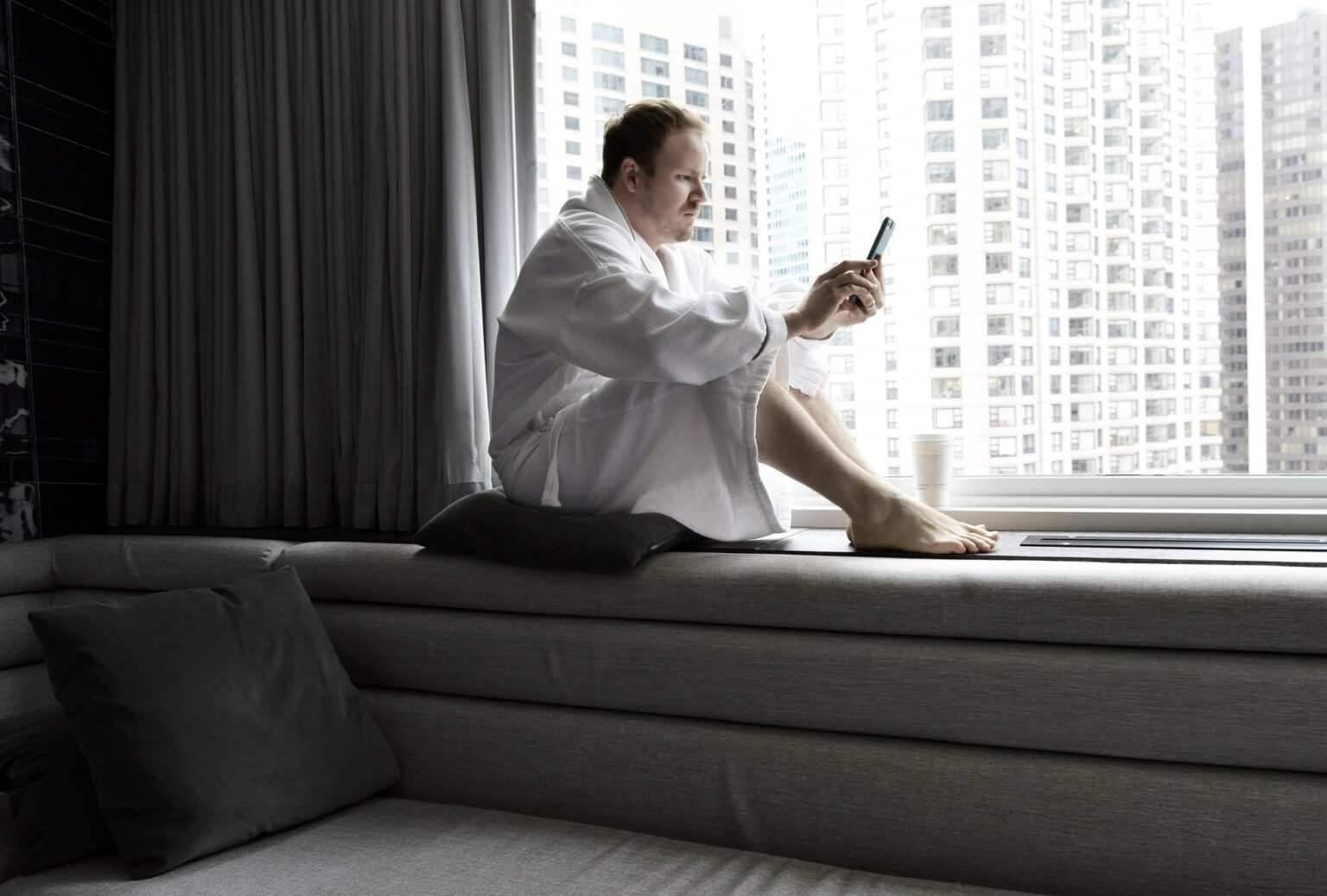 News addiction can overtake your life, as it may have with this person reading in a hotel room.