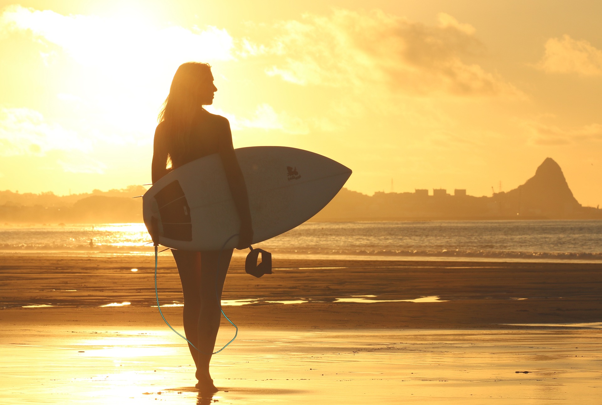 Self-care and depression involves being good to yourself, like this woman going surfing.