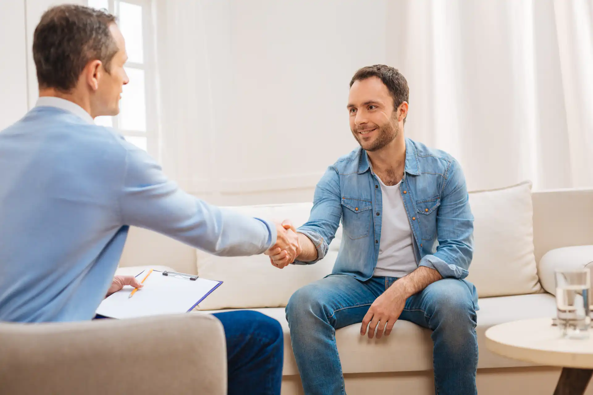 happy man shaking hands with his psychologist after discussing schizoaffective disorder